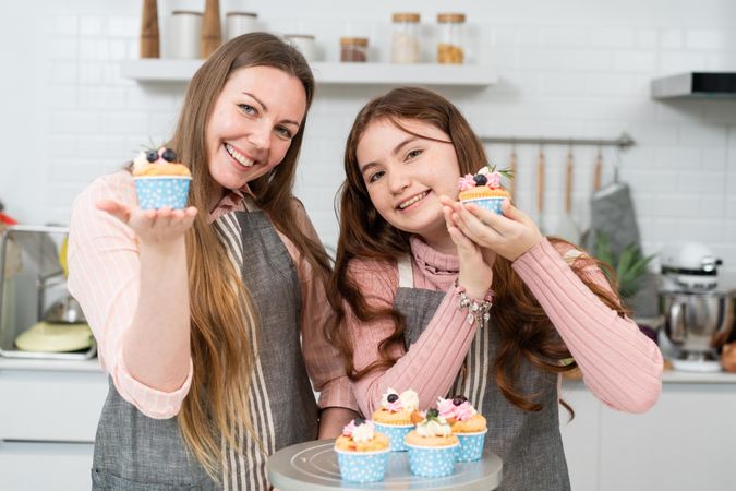 Mother teaching daughter baking at home