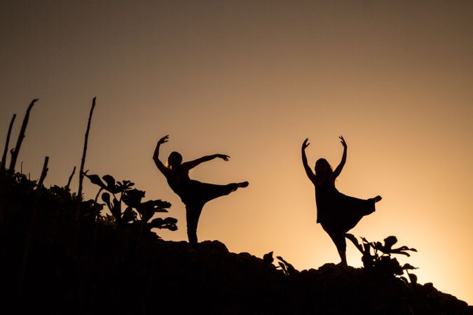 Women posing on hill in darkness