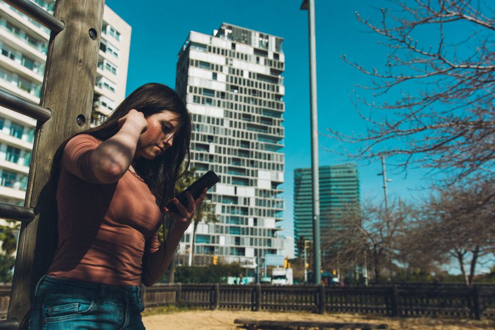 Woman browsing smartphone in city