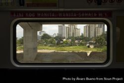 Exterior from inside one of the wagons of the KTM train line, in Kuala Lumpur, Malaysia bYRy10