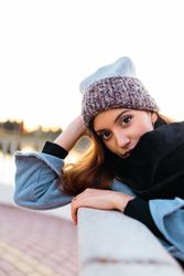 Charming woman in casual wear on shore of lake