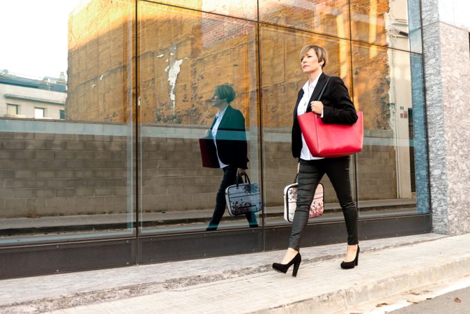 Trendy businesswoman walking down street in heels