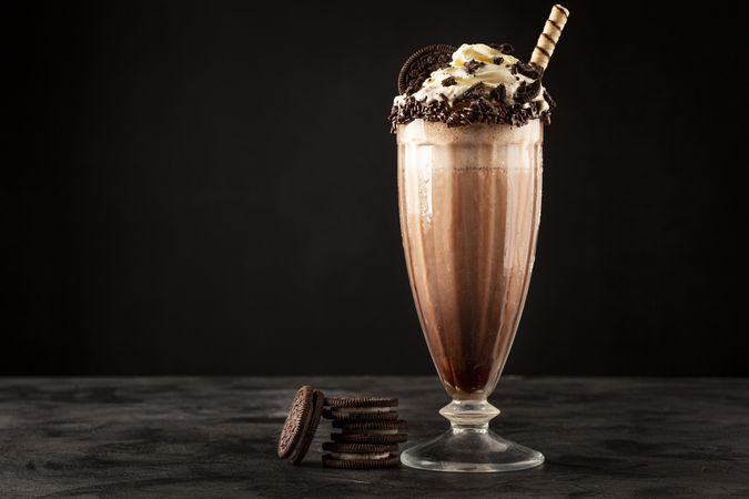 Chocolate milkshake with pieces of chocolate chip cookies.