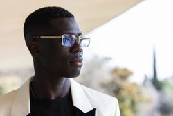 Stylish Black businessman in eyeglasses in town