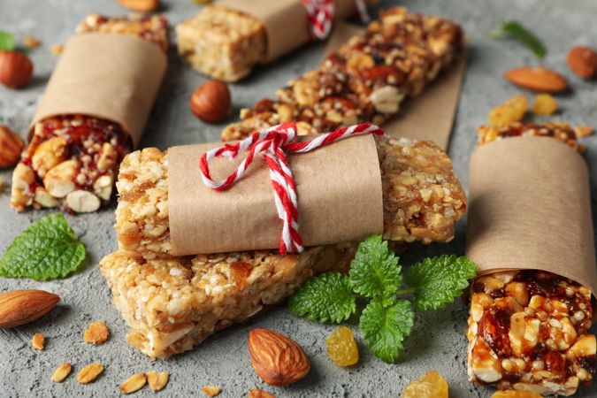 Tasty granola bars on gray background, close up
