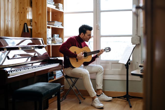 Man playing guitar in studio