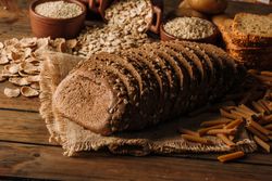 Freshly baked rye bread on napkin on table