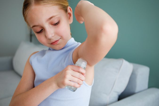 child uses a ball deodorant