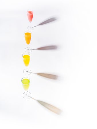 Glasses of bright colorful drinks on table