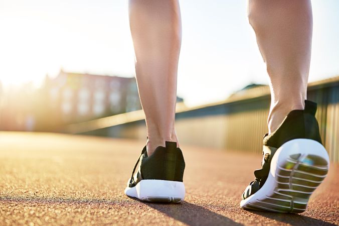 Close up of woman’s calf and feet in running shoes