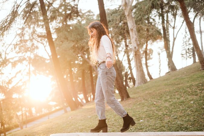 Young woman walking on border in park
