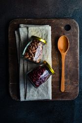 Two jars of dried beans on kitchen counter
