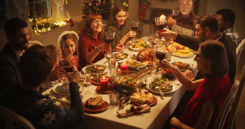 Christmas Celebration at Home with Multicultural Group of Loved Ones Enjoying a Turkey Dinner.
