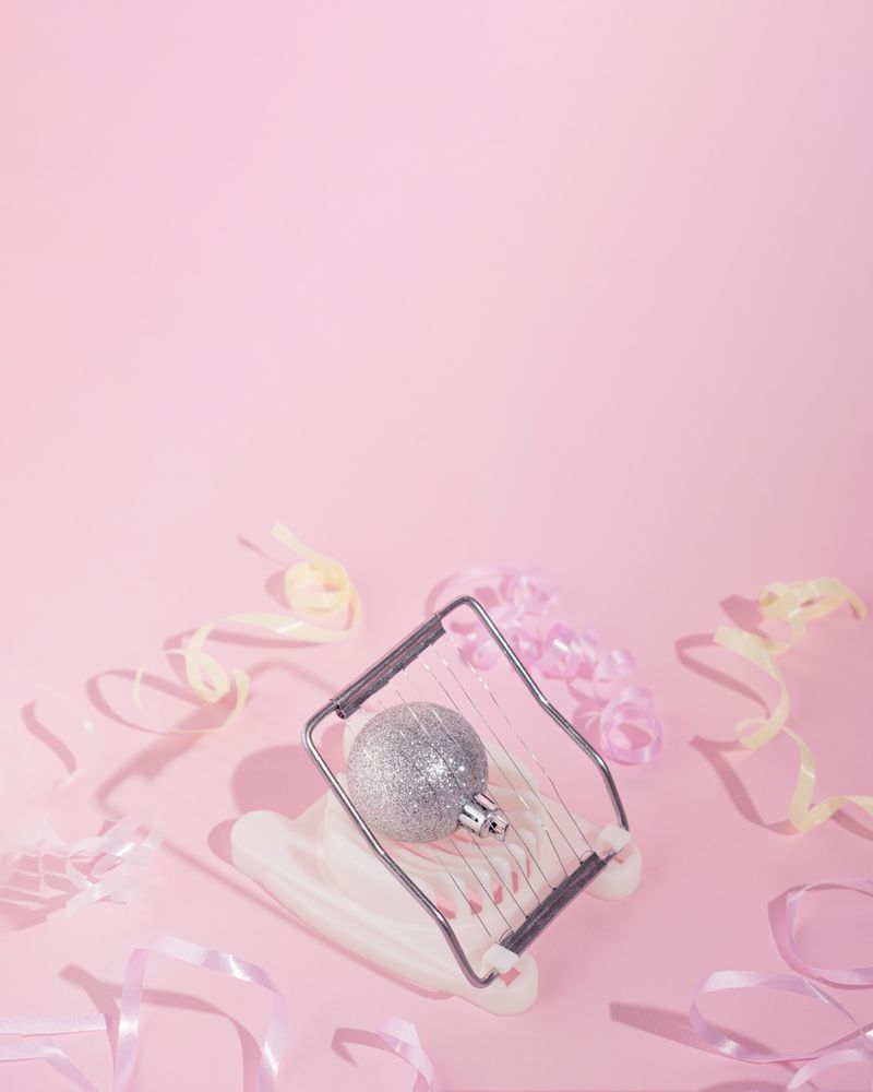 Sparkly silver Christmas ornament in egg cutter with ribbons