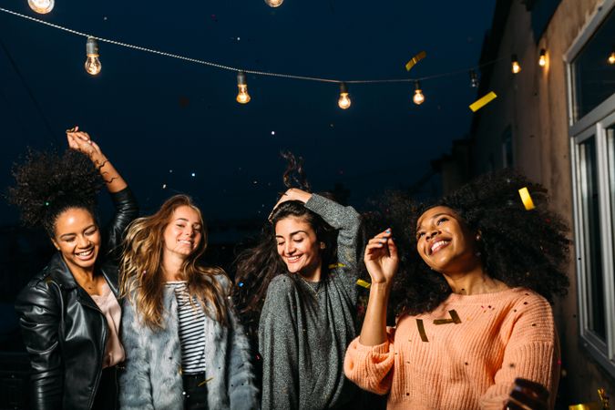 Multi-ethnic group of women having fun celebrating outside