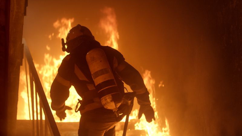Firefighter running toward fire
