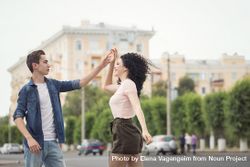 A teenage boy and a girl are dancing in the street 5lyjY4