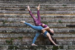 Flexible women practicing acro yoga together