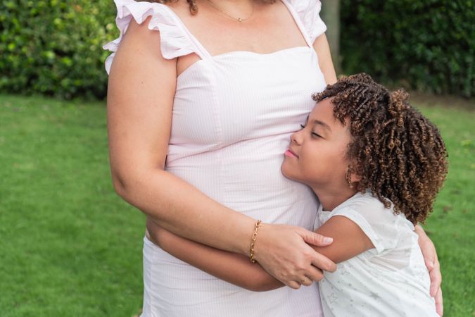 Girl hugging her mother in the open air