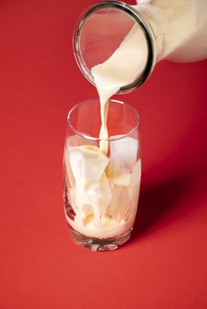 Pouring horchata into an empty glass