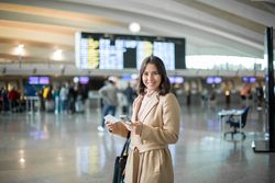 Woman using smartphone at airport