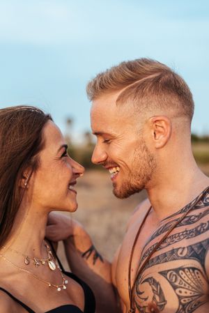 Cool dreamy couple in swimwear on shore
