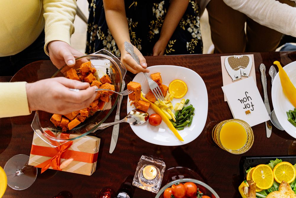Top view of three people sitting at dinner table eating