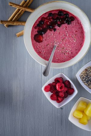 Smoothie bowl with fresh berries and sesame served on table