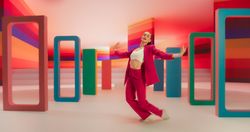 Professional Female Performer Energetically Rehearsing a Modern Dance Choreography in a Colorful Spacious Studio. Stylish Woman Looking at the Camera and Dancing Expressively, Practicing Her Routine
