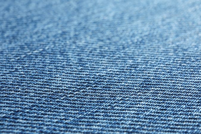 Texture of blue jeans as background, space for text