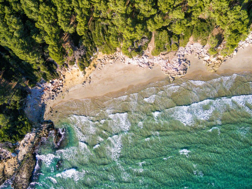 Looking down at idyllic beach with waves coming in