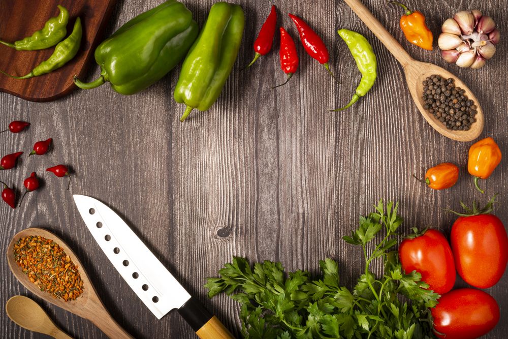 Ingredients for cooking with tomatoes, various peppers, garlic and green peppers.