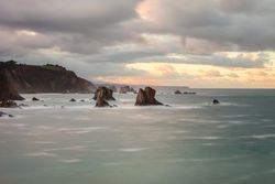 Storm with blustering waves on rocky coast