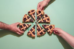 Grabbing slices of blueberry pie