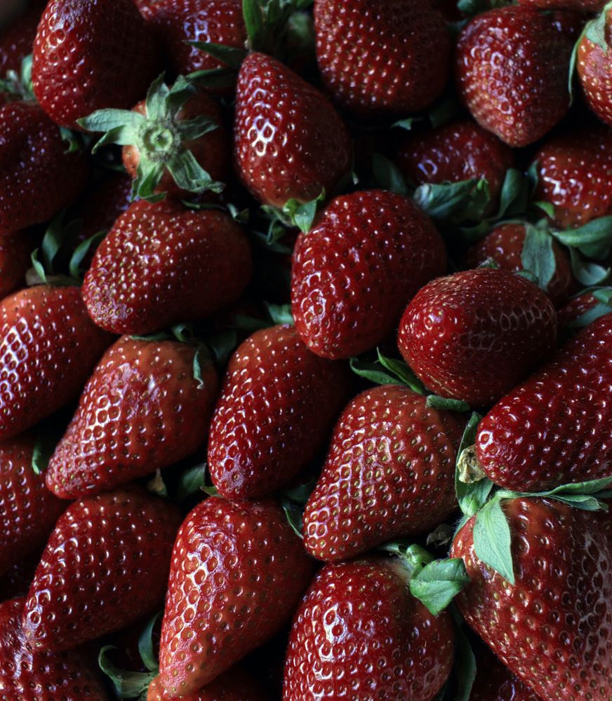 Heap of ripe strawberries with leaves