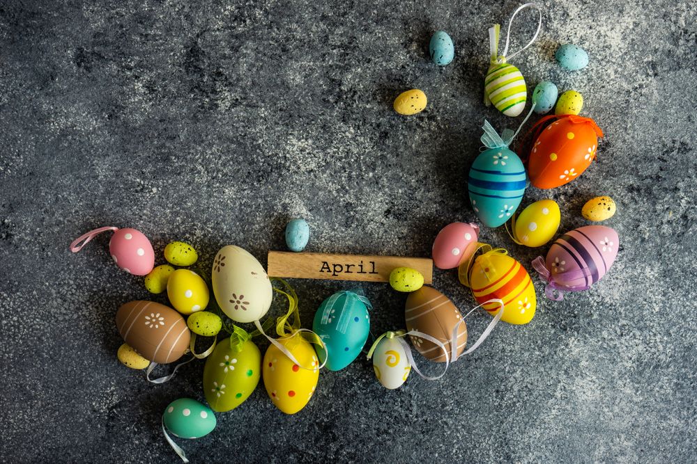 Easter card concept of grey counter scattered with decorative small eggs