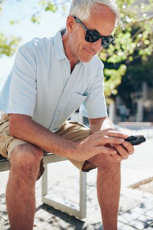Close up portrait of man using mobile phone outside