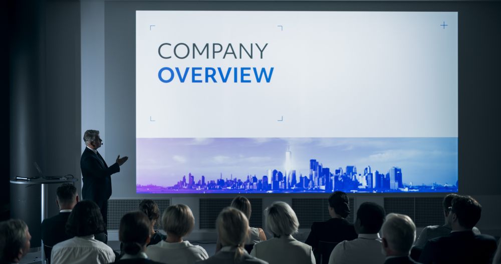 Corporate Event: Male Top Manager Giving Presentation To Colleagues or Investors In Conference Room Of Innovative Startup Office.