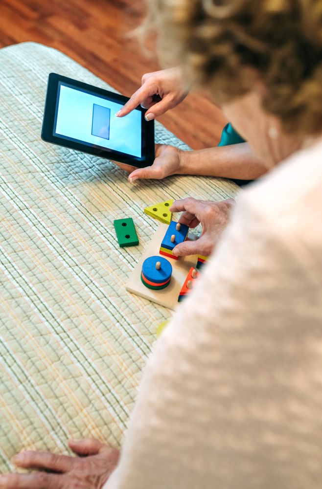Female doctor showing geometric shapes to patient