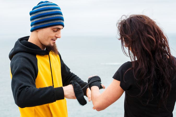 Kickboxers bandaging hands before outdoor training