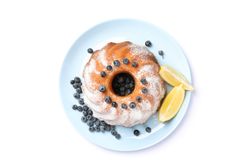 Cake with powdered sugar, blueberry and lemon isolated on blank background