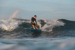 Man on surf board on waving water