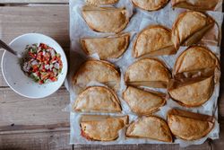 Baking tray with composed freshly baked pies patty