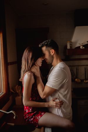Happy couple kissing in kitchen