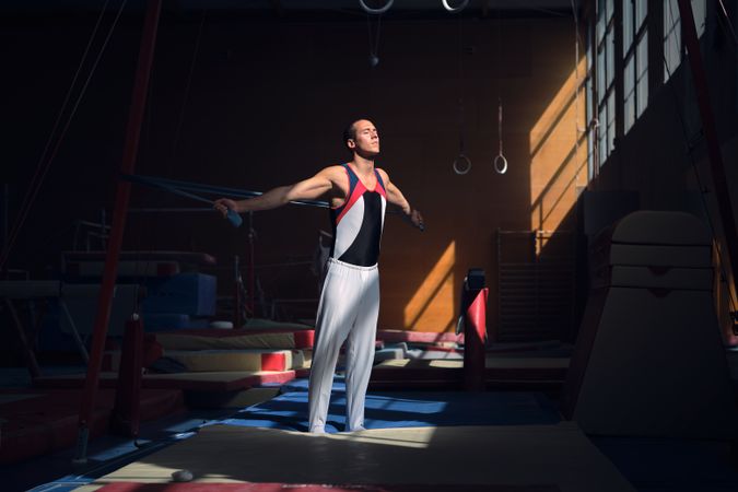 Young sports gymnast stretching with a rubber band in the gymnas