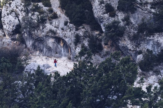 Woman walking between stone hills