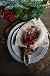Top view of holly berries on xmas table setting