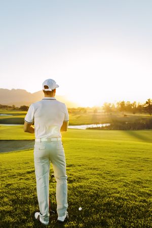 Professional male golfer playing on a sunny day
