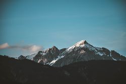 Snow covered mountain under blue sky