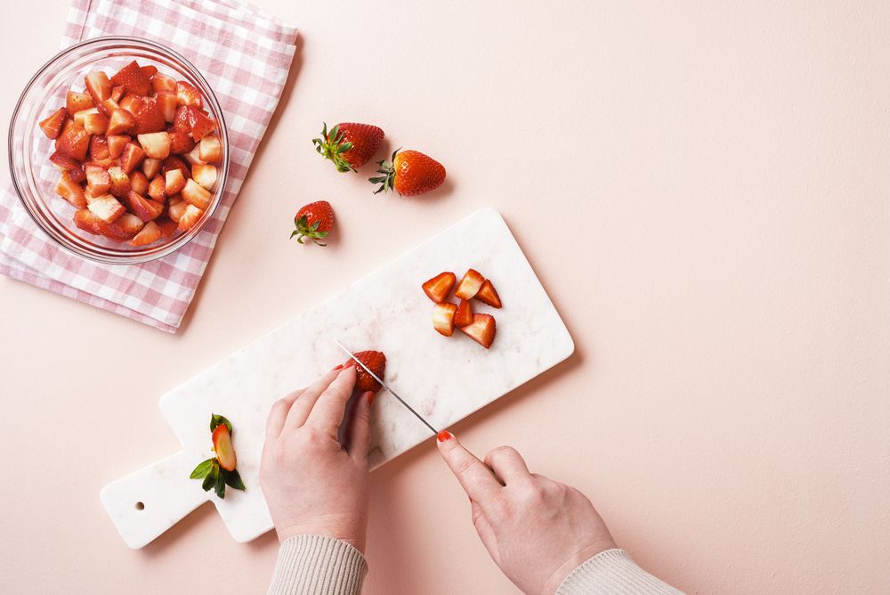 Slicing strawberry for making strawberry jam